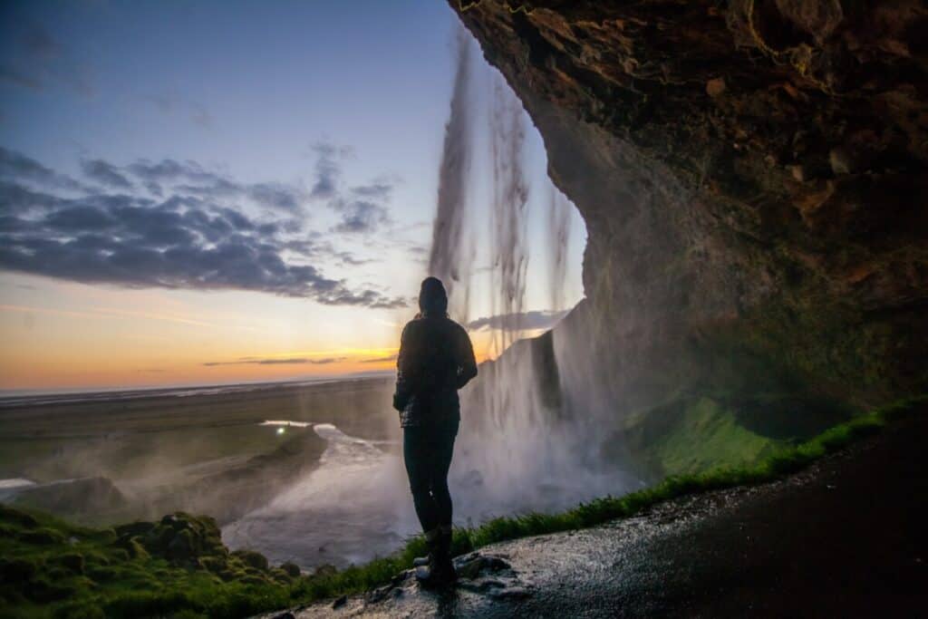 Man showring in waterfall