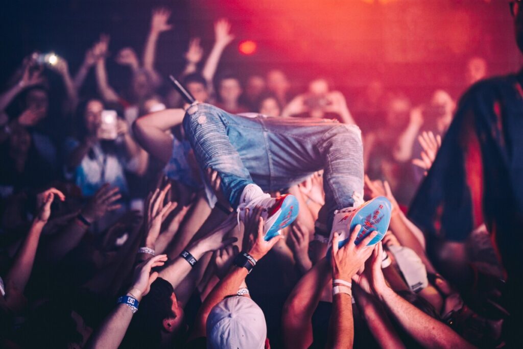 Man crowd surfing at concert