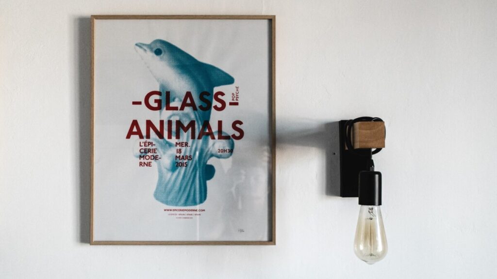 Framed poster and light fixture on wall
