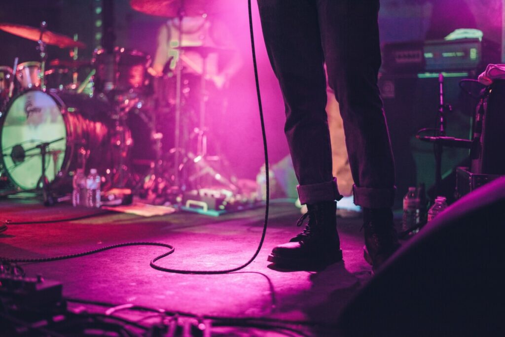 Waist down photo of man on concert stage