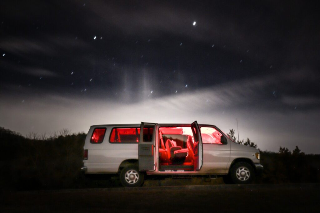 Band van with doors open at night