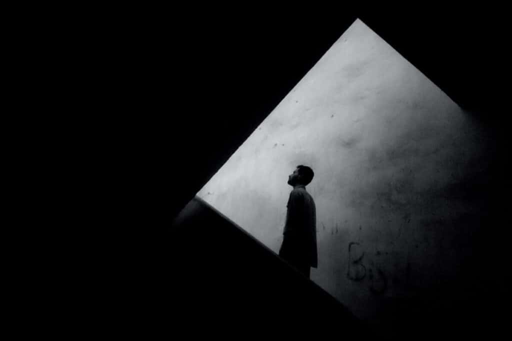 Silhouette of a man looking into darkness