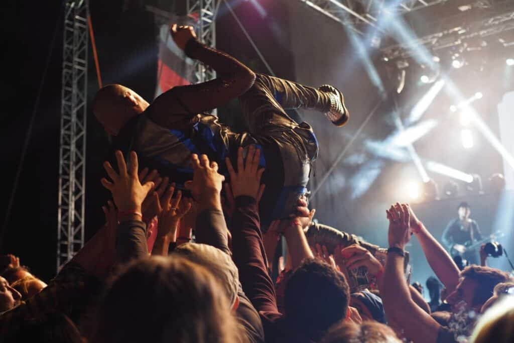 A man crowd surfing at a concert