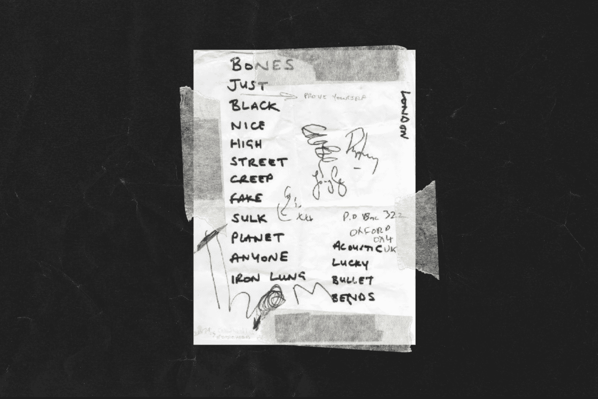 A handwritten setlist taped to floor